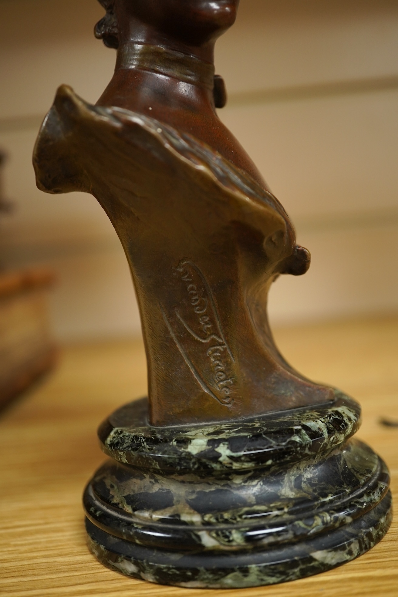 George Van Der Straeten (Belgium, 1856-1928) A bronze bust of a lady wearing a hat, signed, mounted on marble base, 21.5cm high